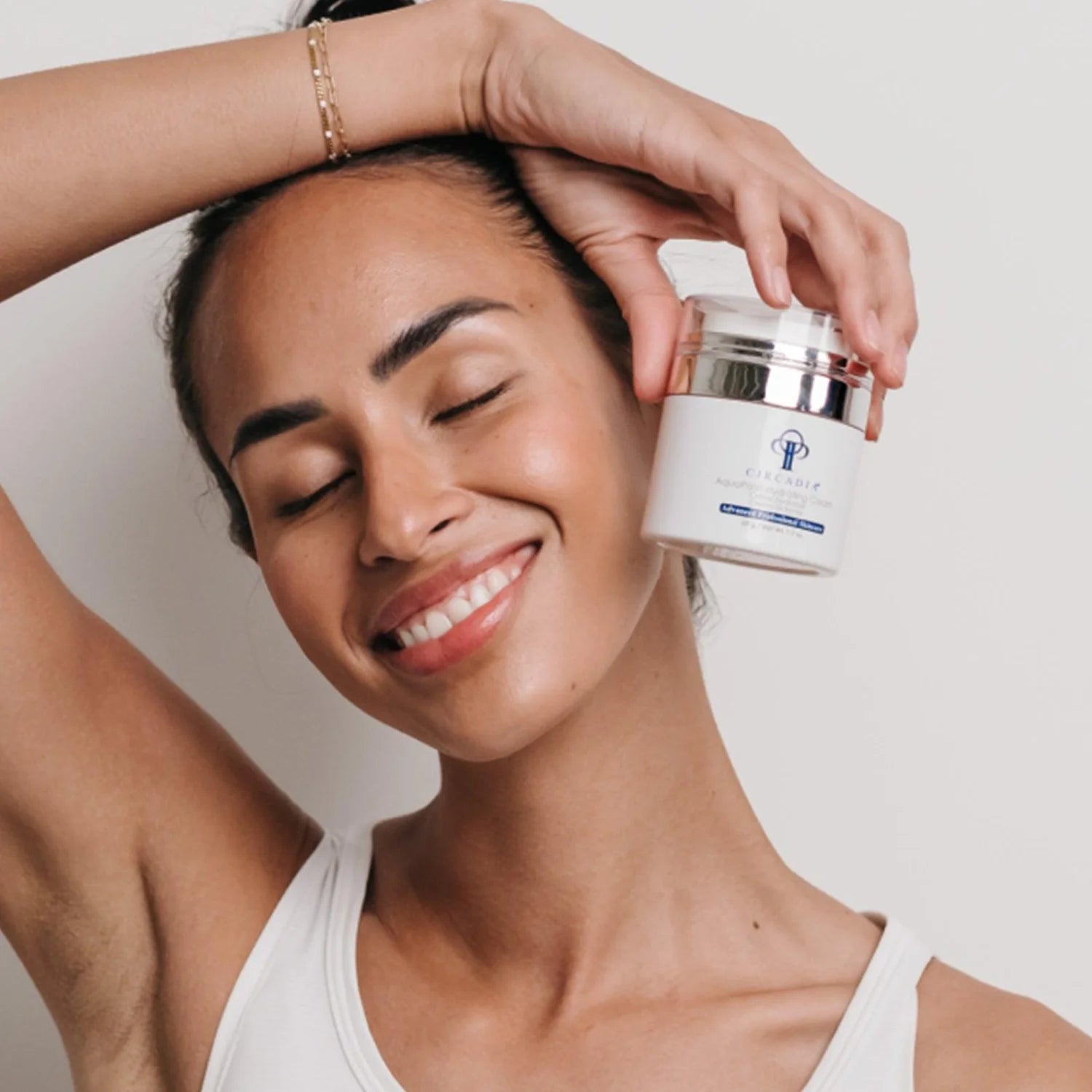 woman holding aquaporin cream by circadia offered at privi studios